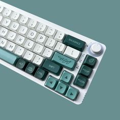 a white and green computer keyboard on a blue background