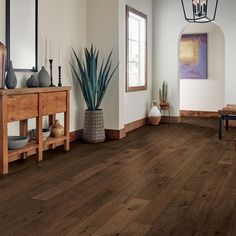 a living room with wood floors and white walls