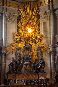 an ornate alter with statues and a stained glass window