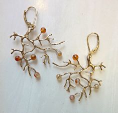 Carnelian Wild Branch Earrings, Bronze or Sterling Silver Organic branch earrings are hand-cast in golden bronze with secure 14k gold-filled lever-back ear wires. They are highlighted with 4mm Carnelian gemstone beads, like tiny berries. Wild and strong, yet delicate, and a bit of nature for your ears. They can also be cast in all sterling silver with sterling lever-back ear wires. The branch was cast in solid eco-friendly bronze using lost-wax casting. I start with a wax model, and then a plast Pendulum Earrings, Vintage Inspired Earrings, Branch Earrings, Plaster Molds, Bronze Jewelry, Celestial Jewelry, Geometric Triangle, Hand Cast, Recycled Sterling Silver