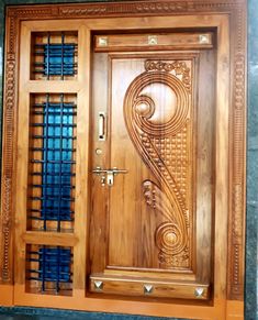 a wooden door with metal bars on the sides and an intricate design at the top