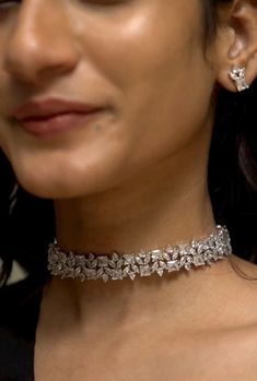 "The American Diamonds / Zirconium choker necklace is designed to grace the neckline elegantly, accentuating the contours of a high neck dress or ensemble. Its sleek and streamlined silhouette hugs the neck with effortless grace, creating a captivating focal point that draws the eye upward. Style this perfect versatile cocktail necklace set with any Indian / Indo Western Attire.   WHAT GOES IN  👉🏻American Diamond / Cubic Zirconia AD Necklace Set with earrings in silver finish.  👉🏻Necklace Le