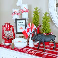 a red and white christmas table with canadian decorations