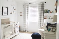 a baby's room is decorated in white and blue