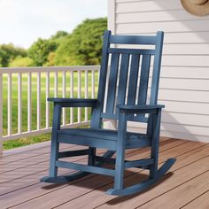 a blue rocking chair sitting on top of a wooden deck