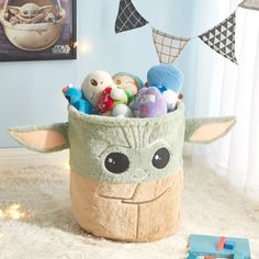 a star wars baby yoda plush toy basket filled with toys