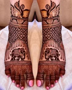 the feet are decorated with henna designs