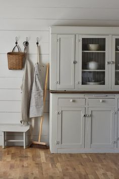 a kitchen with white walls and wooden floors