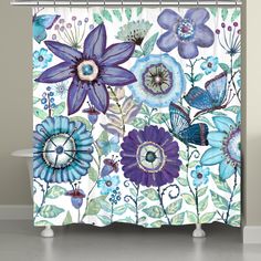 a shower curtain with blue flowers and butterflies on the outside, in front of a bathtub