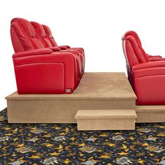 two red reclining chairs sitting on top of a wooden platform