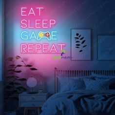 a neon sign that reads eat sleep game repeat on the wall above a bed in a bedroom