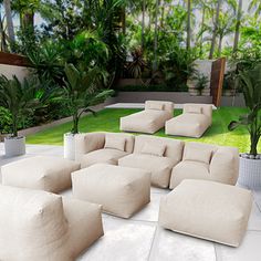 an outdoor living room with white furniture and plants