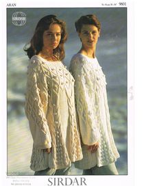 two women in white sweaters standing next to each other with the words sirdar on them