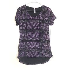 Step into a world of comfort and style with our stunning LuLaRoe Women's Classic T-Shirt in a captivating Black/Purple geometric pattern. This short-sleeve tee is crafted from a soft, breathable polyester blend that feels luxurious against your skin, making it the perfect choice for any season. Whether you're dressing up for a casual outing or lounging at home, this versatile piece will elevate your wardrobe with its eye-catching design and flattering fit.LuLaRoe Classic T-Shirt Details Size: S Cheap Purple Blouse, Affordable Fitted Purple Blouse, Cheap Festive Purple Blouse, Vintage Trucker Hats, Purple Pattern, Halloween Women, Tops For Leggings, Skirt Top, Geometric Design