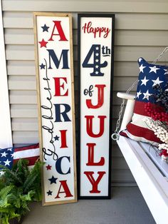 two wooden signs that say happy 4th of july and fourth of july on the front porch