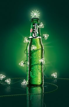 a green beer bottle with lights around it