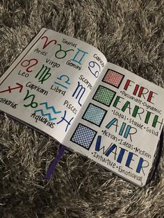 an open book with writing on it sitting on top of a carpet covered in grass