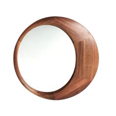 a circular mirror with wooden frame on a white background, showing the reflection of an object in it