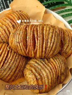 some fried food in a bowl on top of a table with chinese writing above it