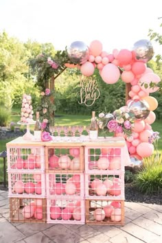 a pink and gold baby shower is set up with balloons, confetti, and decorations