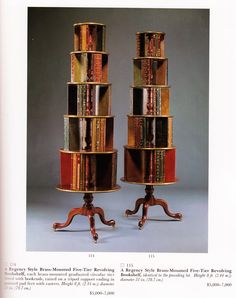 two wooden bookshelves sitting on top of each other in front of a gray background