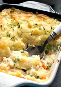 a casserole dish with chicken, potatoes and carrots