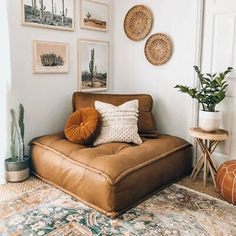 a living room filled with furniture and pictures on the wall