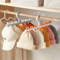 a rack with hats and sweaters hanging from it