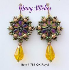 a pair of earrings with yellow and green beads on them, sitting next to each other