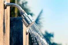 a faucet that is spraying water out of it's spouter