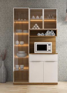 a microwave oven sitting on top of a wooden counter next to a shelf filled with dishes