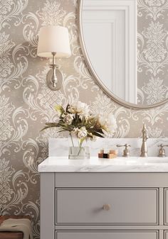 a bathroom with a vanity, mirror and flowers