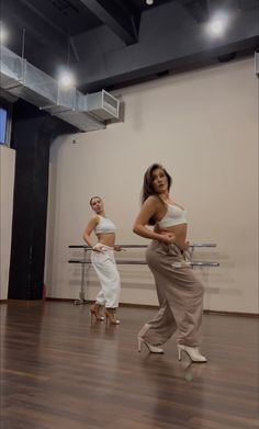 two women are dancing in a dance studio