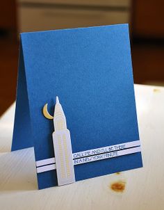 a blue card with a city skyline on it and a crescent hanging from the front