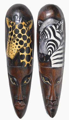 two african masks with zebras and giraffes on their heads, one is painted black