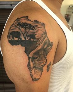 a man with a tattoo on his arm that has an elephant and tree on it