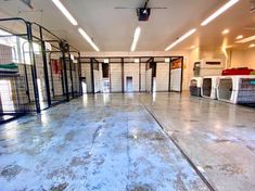 an indoor dog kennel with doors open