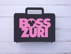 a black and pink box with the word boss zuri on it