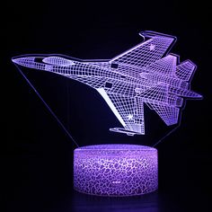 an illuminated model of a fighter jet in the dark