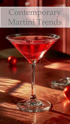 a close up of a drink in a wine glass on a table with the words contemporary martini trend