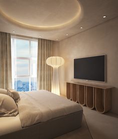 a bedroom with a large flat screen tv mounted on the wall next to a bed