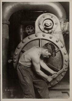 an old black and white photo of a man working