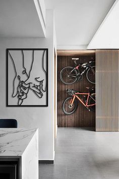 two bikes are mounted to the wall in this modern home