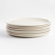 six white plates stacked on top of each other in front of a white background,