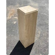 a wooden box sitting on top of a parking lot next to a cement floor and sidewalk