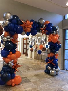 an arch made out of balloons and streamers