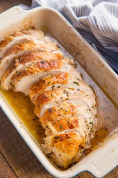 a chicken breast in a casserole dish on a wooden table