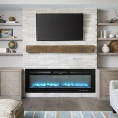 a living room with a television and fireplace in the center, built - in shelving