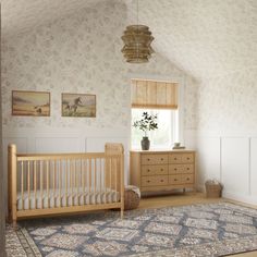 a baby's room with a crib, dresser and rug on the floor