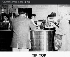 an old photo of people in a kitchen cooking and washing their hands at the sink